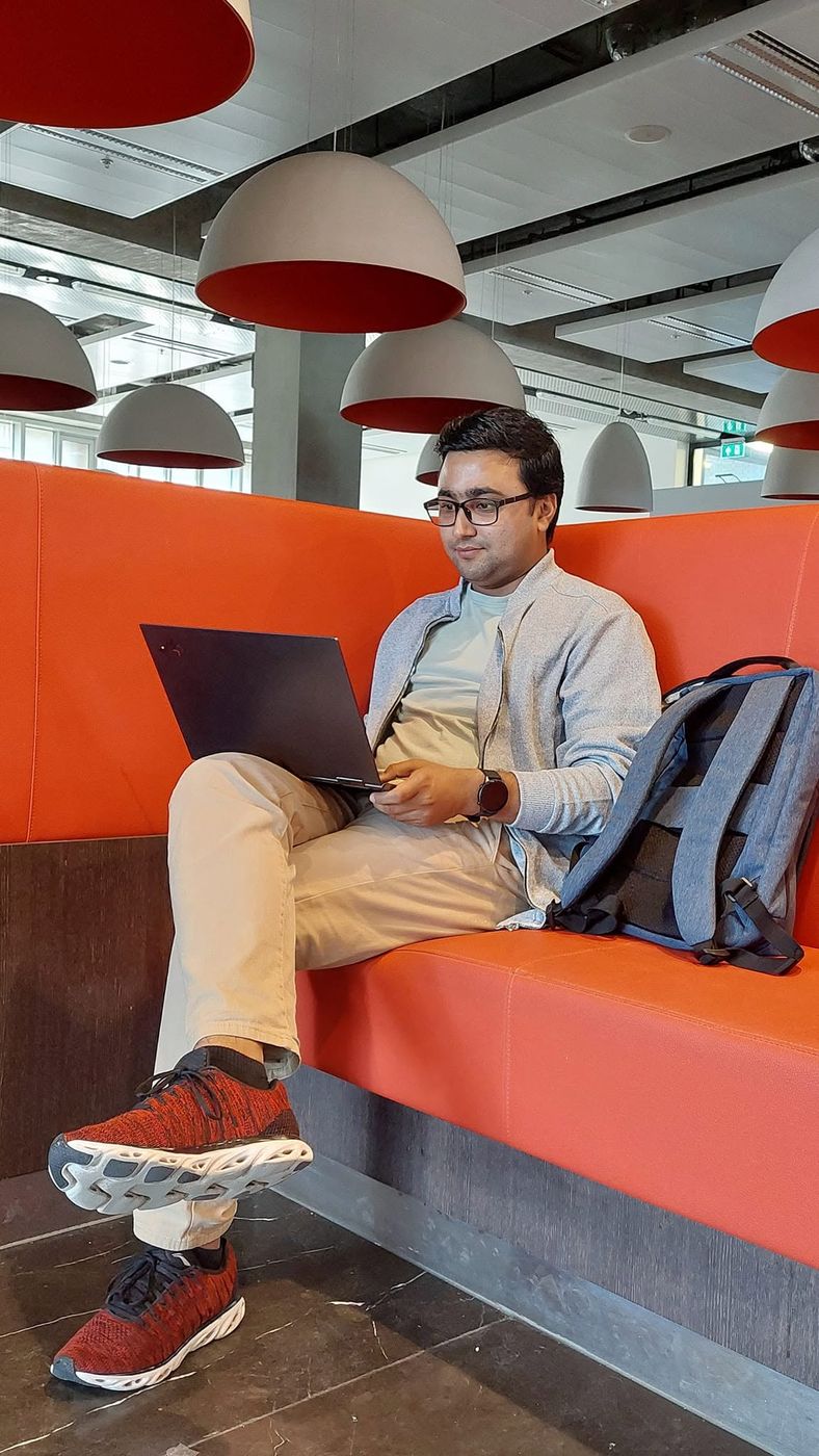 Kailash working on a laptop on campus