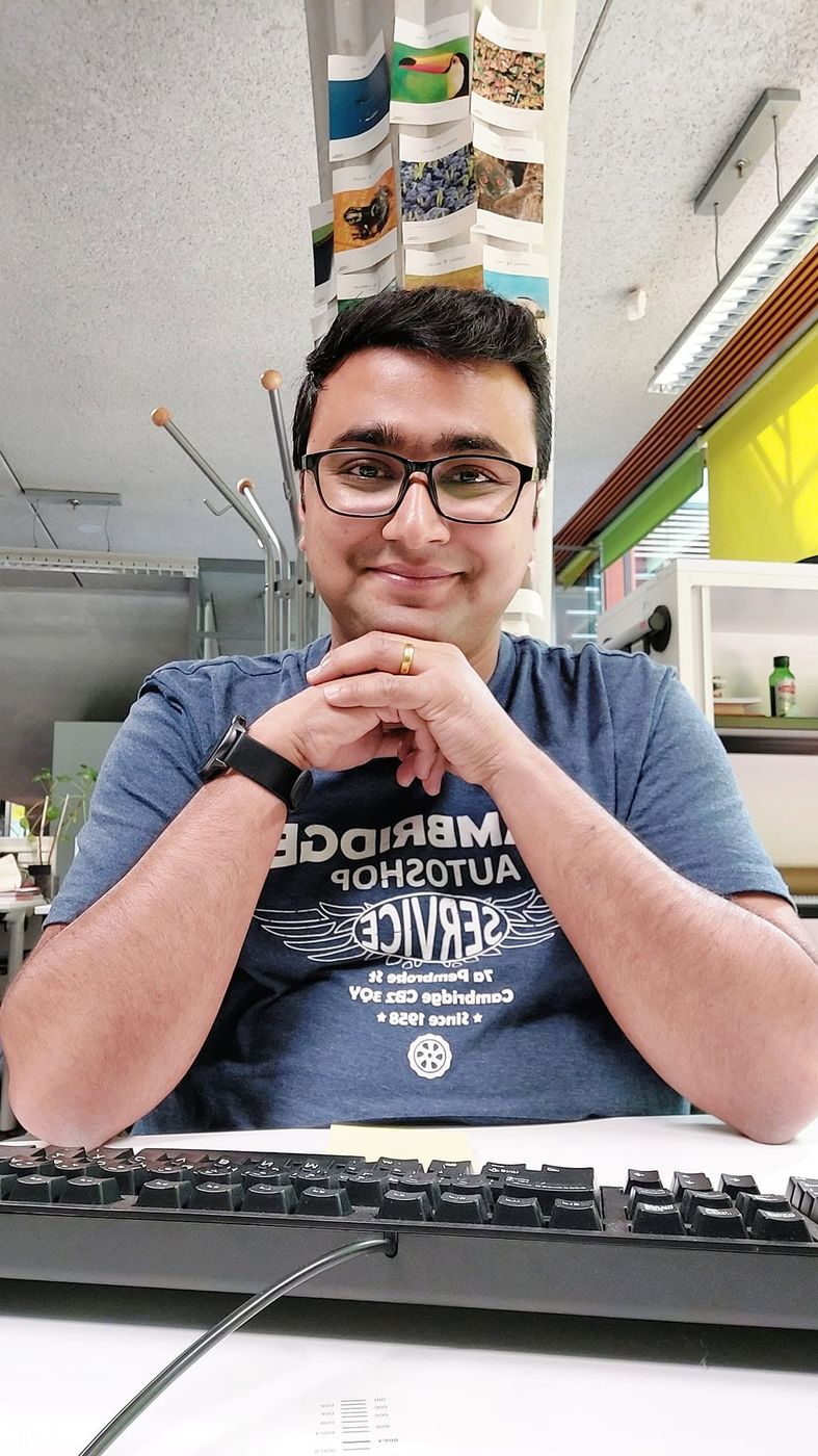 Kailash smiling at his office desk