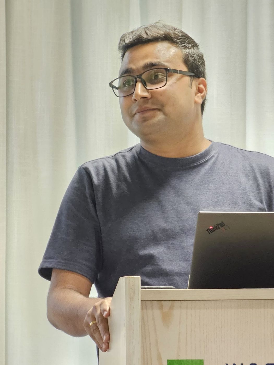Kailash answering questions at a conference podium